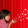 Girl blowing hearts