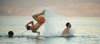 Young boys jumping in the sea