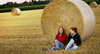 Two Girls sitting in Field wit